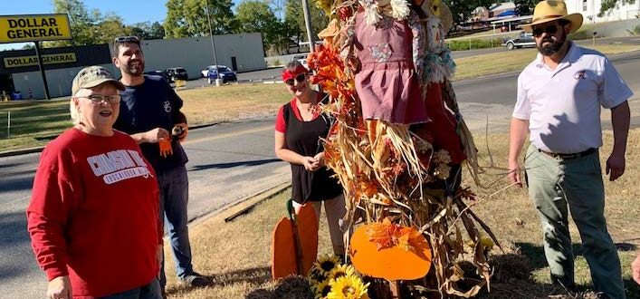 Garden Club members Rollanda Cothran, Buzzy Barnette, Eve Kneeland and Mason Dyess work to spruce up Greensboro with fall decorations as part of a recent club beautification project. The Garden Club will hold a fall plant sale this Saturday at Greensboro First United Methodist Church.